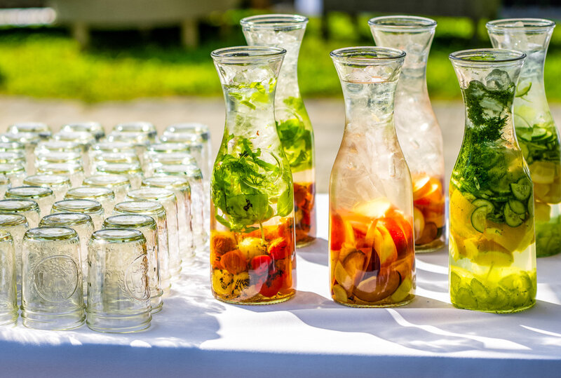 Filled water carafes with mint and assorted fruits and vegetables