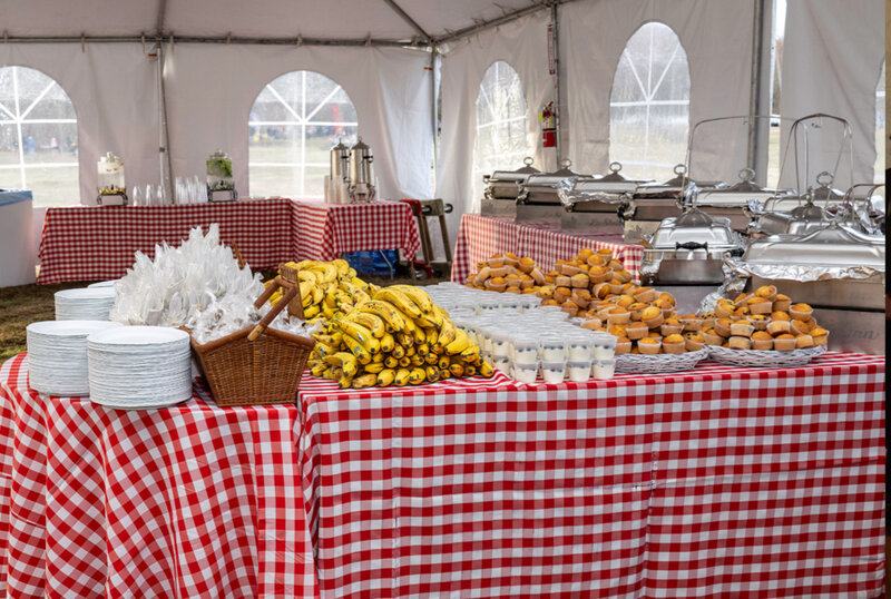 Tables with chaffing dishes, bananas, yogurt and muffins