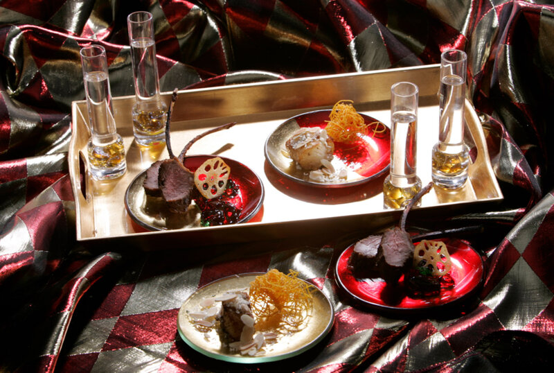 Plated entrees and cocktails on serving trays