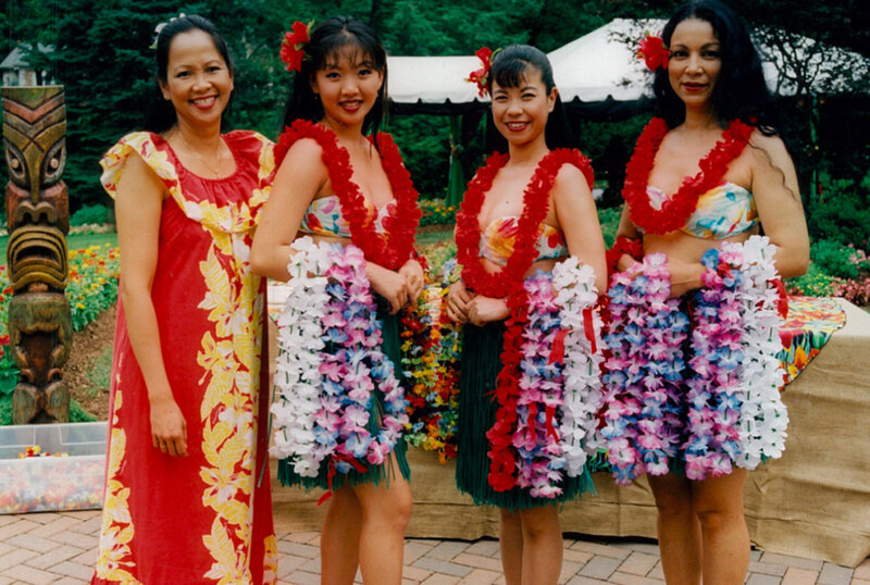 Luau dancers holding leis