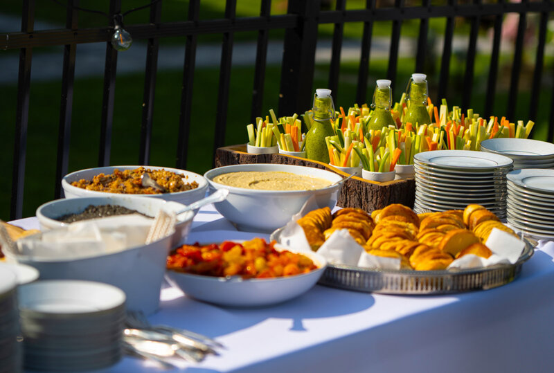Bread, vegetables and spreads on table