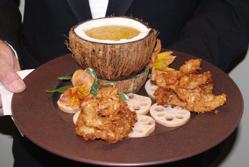 Serving tray with fried shrimp, tomatoes and coconut with dippiing sauce